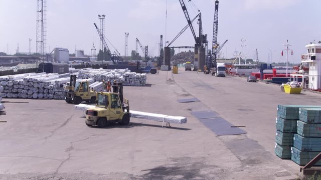 Forklift trucks stacking steel at groveport docks.