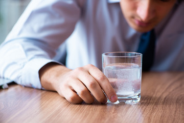 Sick male employee suffering in the office
