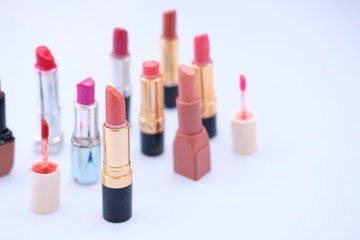 lipstick and nail polish on white background