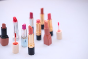 lipstick and nail polish on white background