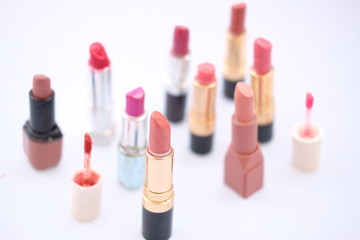 lipstick and nail polish on white background