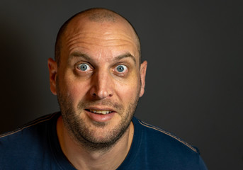 portrait of bald man with blue eyes