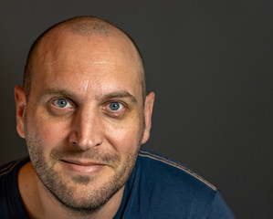 portrait of bald man with blue eyes