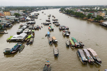 Cai Rang Floating Market on the Mekong River in the morning from aerial perspective featuring the river boats