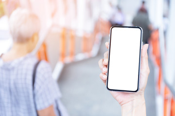 Mockup image blank white screen cell phone.men hand holding texting using mobile on subway. background empty space for advertise text.people contact marketing business and technology 