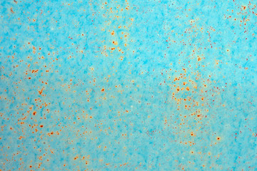 background: rusty metal surface with blue paint flaking and cracking texture