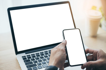 mockup image blank screen computer,cell phone with white background for advertising text,hand man using laptop texting mobile contact business search information on desk in office.marketing design 