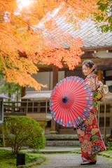 woman in old fashion style wearing traditional or original Japanese dressed, walks alone in the...
