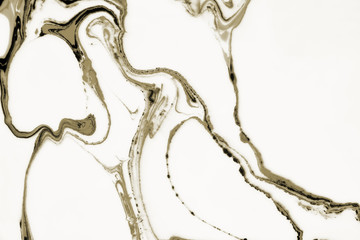 Modern painting in the technique of Ebru and suminagashi. Abstract drawings on water with acrylic paints.Marble liquid texture.
