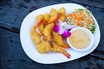 Batter fried prawns with dipping sauce.