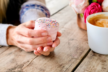 Cup of coffee, cake and flowers.