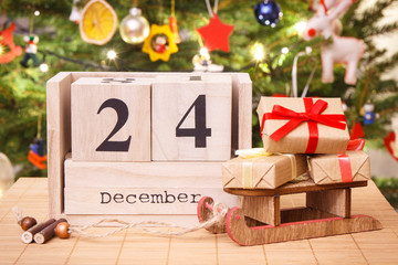 Date 24 December on calendar, wrapped gifts and christmas tree with decoration, Christmas eve time...