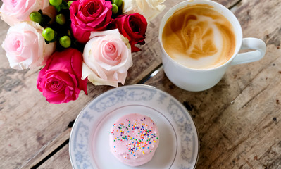 Obraz na płótnie Canvas Cup of coffee, cake and flowers.