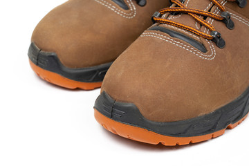 New shoes for working with laces. Safety shoes on a white background , Work shoes for men in factory or industry to protect foot from accident.