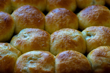 Baked hot buns. Sweet buns on a baking sheet
