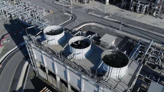 Cooling tower tank with pipe line for transfer heat power from oil refinery plant before release into air for reduction heat pollution.