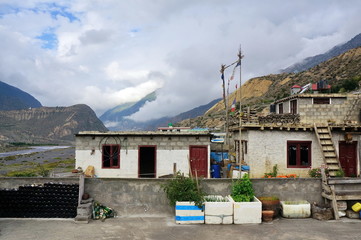 Typical Nepalese houses made of blocks with flowers in front of them in the city of Jomsom in Nepal, Mustang district.