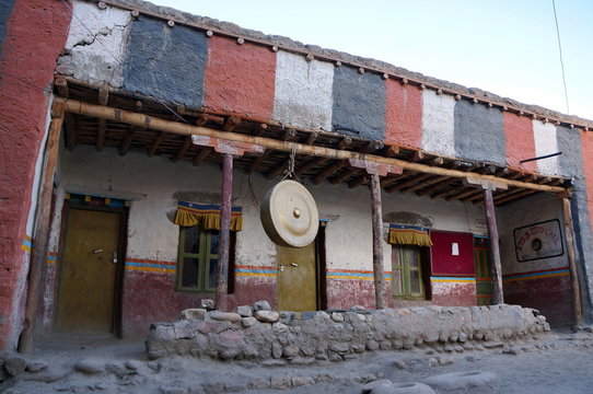 A sacred gong hangs in the courtyard in Tsarang Gompa (1395) - Sakya Monastery. Trekking to the Upper Mustang enclosed area. Nepal.