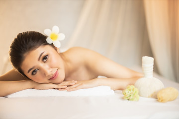 Fototapeta na wymiar Asian Beautiful, young and healthy woman in spa salon. Massage treatment spa room . Traditional medicine and healing concept.