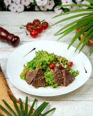 herb salad topped with fried meat