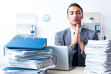 Naklejka premium Businessman with heavy paperwork workload