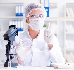 Female scientist researcher conducting an experiment in a labora