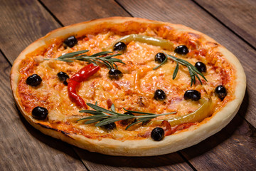 Tasty fresh hot pizza against a dark background. Pizza, food, vegetable, mushrooms