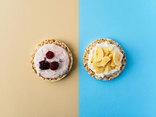 Dessert on blue and yellow background. Crispbread, cottage cheese and fruit