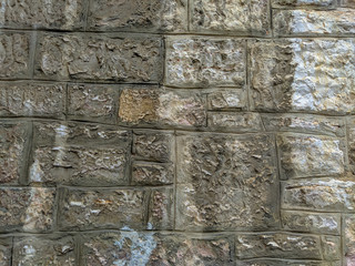 Old looking stone rocks wall or floor with bricks tiles stacked on each other with cement and other rough material, professional masonry background wallpaper