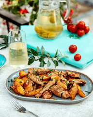 fried chicken and potatoes in sauce