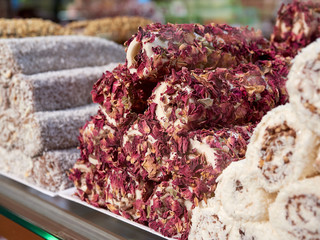 Turkish delight for dessert. Lokum dish with different flavors on sale in Istanbul food store.Traditional sweet locum with sugar for snack