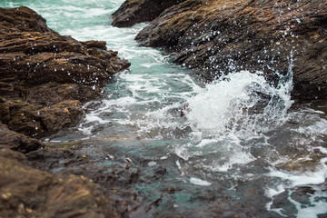 Water splashing on rocks in the sea.