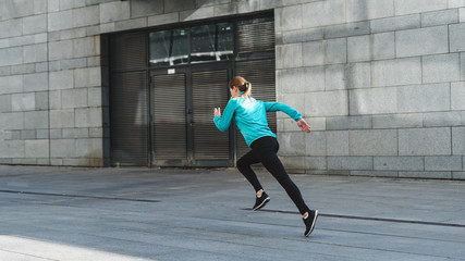 Fototapeta na wymiar Young adult woman running on sport training outdoor