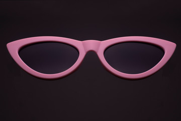 pink retro sunglasses, cat's eye isolated on black - 306641329