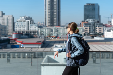  Young adult woman  walking in city at weekend