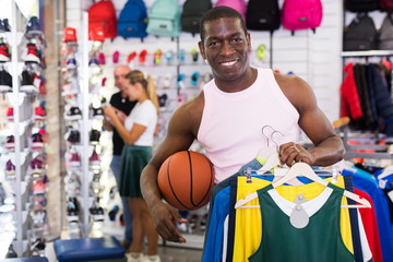 Male customer holding sport clothes