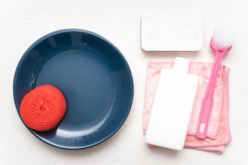 Dish washing accessories on the white flat lay background. Washing up concept.