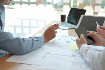 user experience UX designer designing web on smart phone layout. UI developer planning working on mobile application prototype