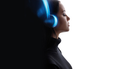 Beautiful woman in headphones listening music with closed eyes. White background. Blue neon light. Free space for text.