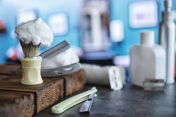 Shaving accessories on a wooden texture background. Tools. Disposable shaving machine, brush, foam and hazard razor.