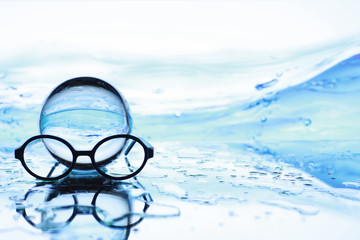 Tools for vision correction. Glasses and lenses with diopters on the background of splashes and...