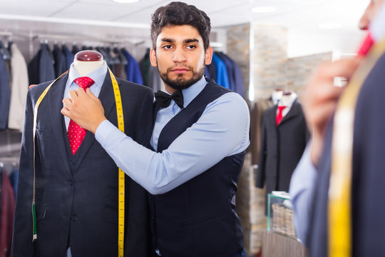 Salesman is creating business image with red tie