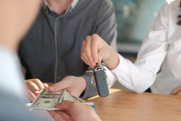 client pay for car. salesman dealer giving key to owner. car sale & dealership in auto business