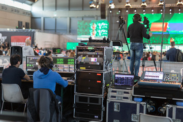 Lighting and Sound Technicians and Television Operators at Work in the BackStage during a Public Event