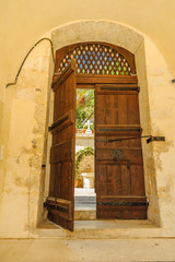 Open old wooden door of the monastery