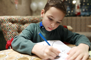 Boy draws with pencil