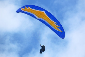 Paraglider flying wing in a blue sky	