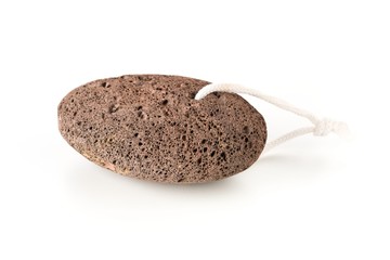 Black lava pumice stone spa or bath utensil used for peeling or callused skin removal over white