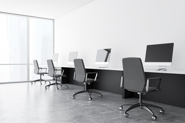 Row of computer tables in open space office