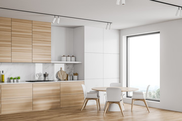 Loft white kitchen corner with round table